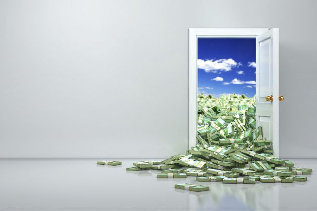 Open door with money spilling through it