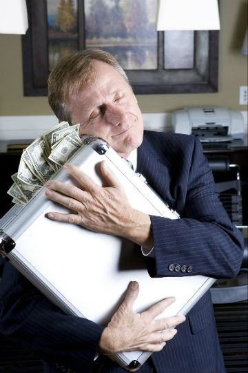 Man holding breifcase of money