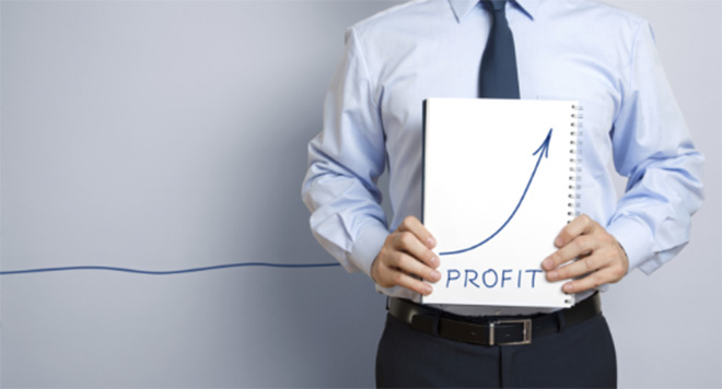 Businessman holding notebook with arrow pointing upwards with the words 'PROFIT' underneath.