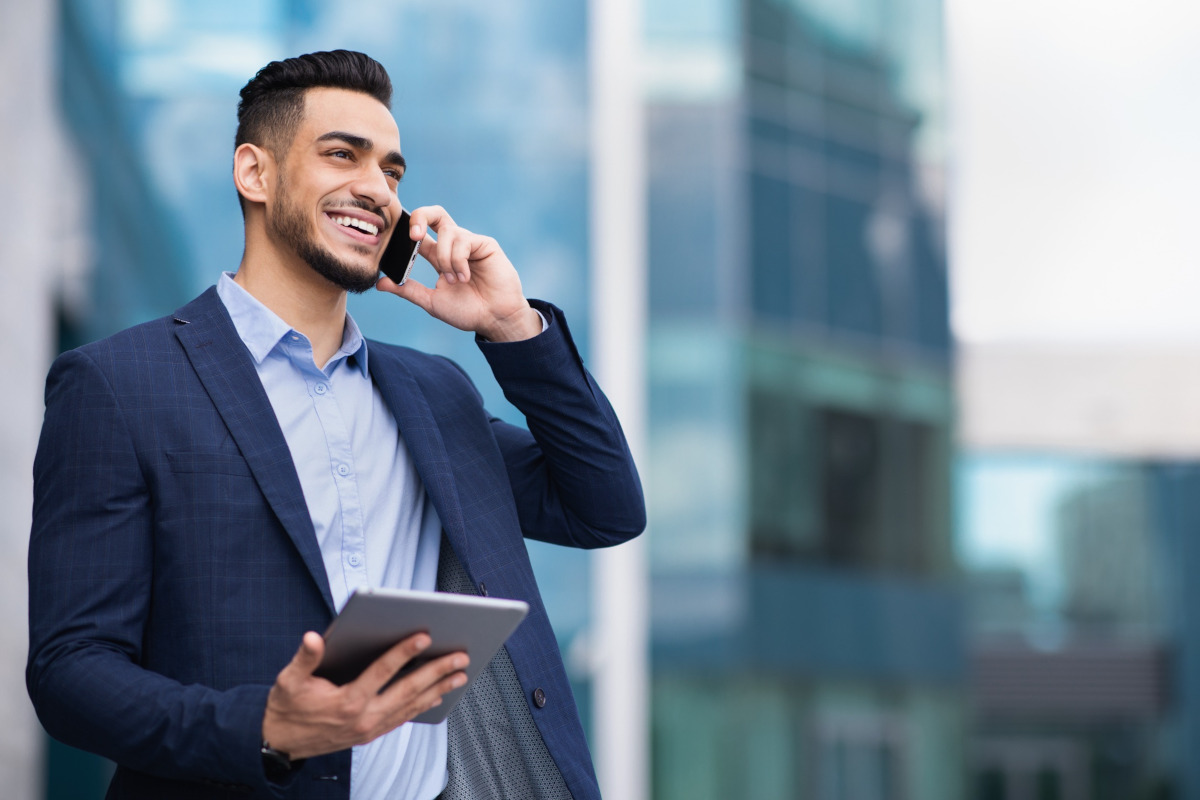 A smiling businessman talking on his cell phone