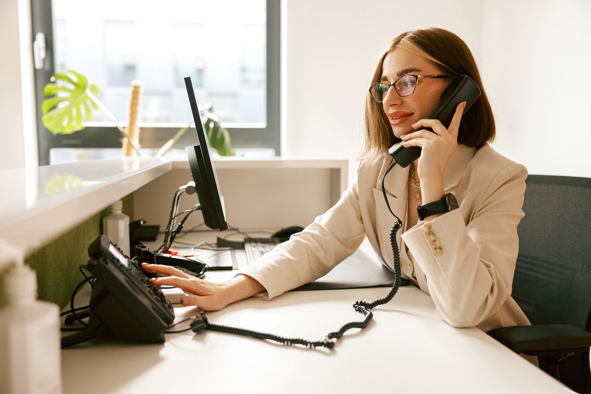 Woman talking on phone in an office.
