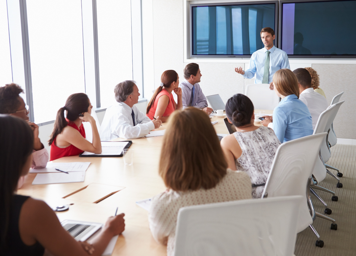 A manager talking to his team in a meeting room