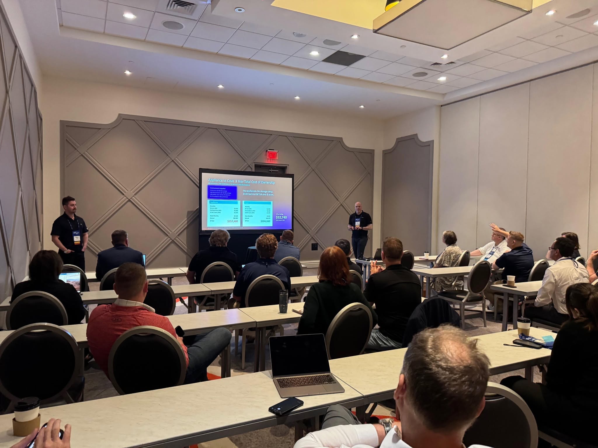 A TAG class in session — an instructor presenting cost-of-ownership figures to a room of Member owners